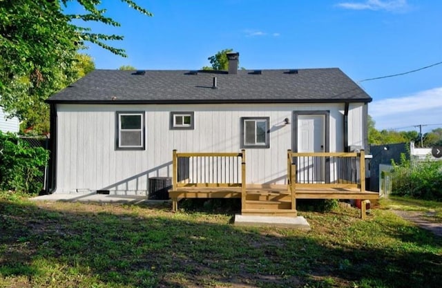 2507 E 69th St, Kansas City, MO 64132 - rear view of house with a wooden deck, a chimney, and a shingled roof