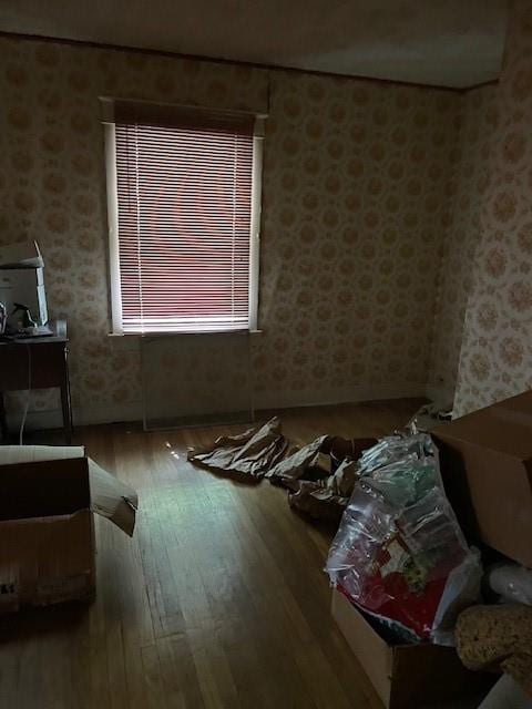 653 Elmwood Ave, Kansas City, MO 64124 - living area with wood-type flooring and wallpapered walls