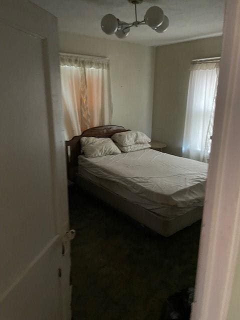653 Elmwood Ave, Kansas City, MO 64124 - bedroom featuring a chandelier and a ceiling fan