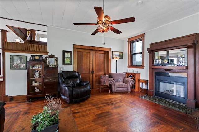 1080 SW 58th Hwy, Holden, MO 64040 - living area featuring a ceiling fan, a fireplace with flush hearth, crown molding, and hardwood / wood-style flooring