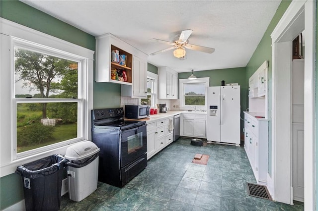1080 SW 58th Hwy, Holden, MO 64040 - kitchen featuring stainless steel appliances, plenty of natural light, white cabinetry, a ceiling fan, and a textured ceiling
