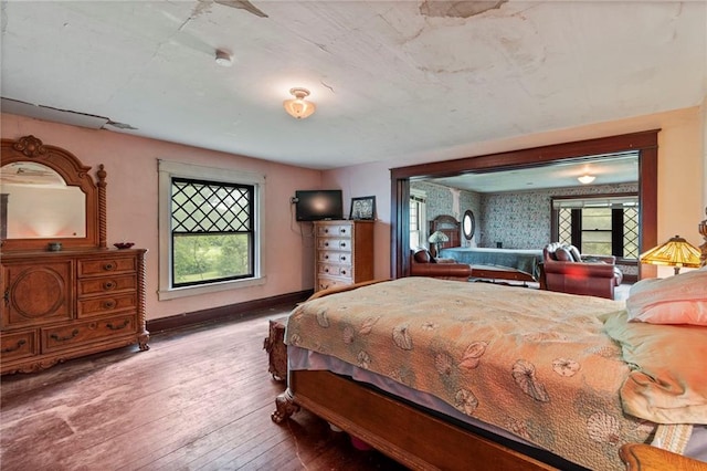 1080 SW 58th Hwy, Holden, MO 64040 - bedroom with hardwood / wood-style flooring and multiple windows