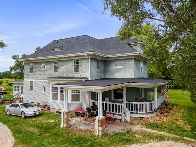 1080 SW 58th Hwy, Holden, MO 64040 - back of house with a yard, a shingled roof, and covered porch