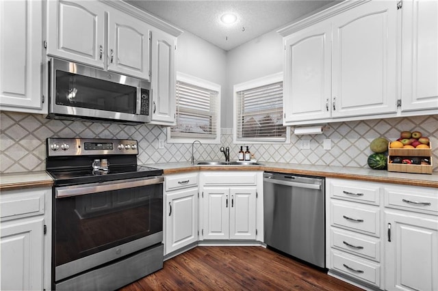 20586 W 220th St, Spring Hill, KS 66083 - kitchen with stainless steel appliances, white cabinets, dark wood-type flooring, light countertops, and a textured ceiling