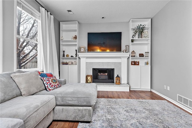 20586 W 220th St, Spring Hill, KS 66083 - living room with wood finished floors, a tiled fireplace, and built in shelves
