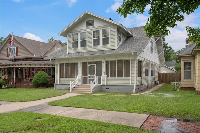 704 Lincoln St, Coffeyville, KS 67337 - view of front facade featuring crawl space, a sunroom, and a shingled roof