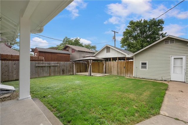 704 Lincoln St, Coffeyville, KS 67337 - fenced backyard with a gazebo and a patio area