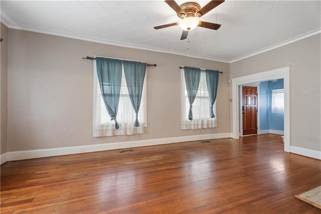 704 Lincoln St, Coffeyville, KS 67337 - empty room with plenty of natural light, ceiling fan, crown molding, and wood-type flooring