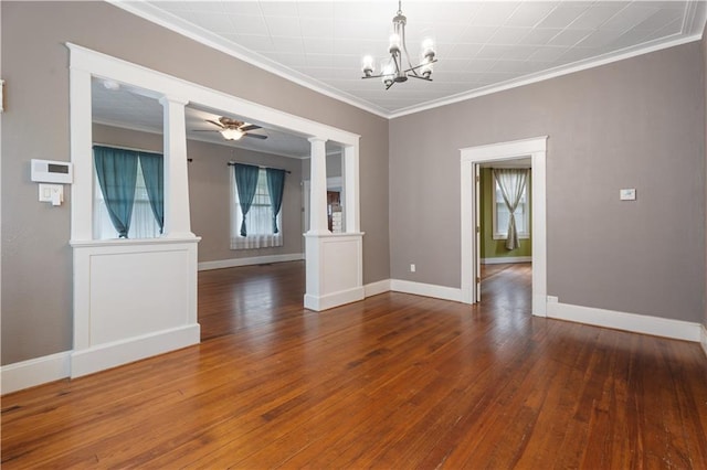 704 Lincoln St, Coffeyville, KS 67337 - unfurnished room with decorative columns, ornamental molding, a chandelier, hardwood / wood-style flooring, and ceiling fan