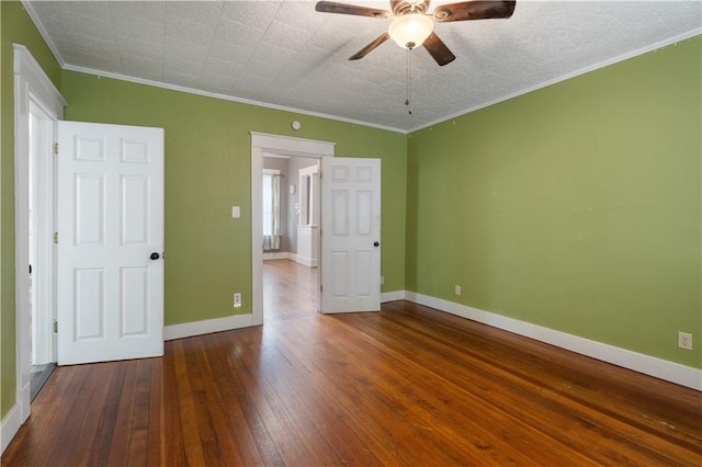 704 Lincoln St, Coffeyville, KS 67337 - unfurnished bedroom with wood-type flooring, ornamental molding, and a ceiling fan