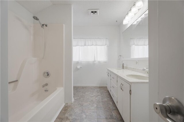 704 Lincoln St, Coffeyville, KS 67337 - bathroom with double vanity, shower / bath combination, and stone finish floors