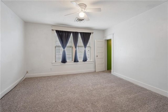 704 Lincoln St, Coffeyville, KS 67337 - unfurnished room with light carpet and ceiling fan