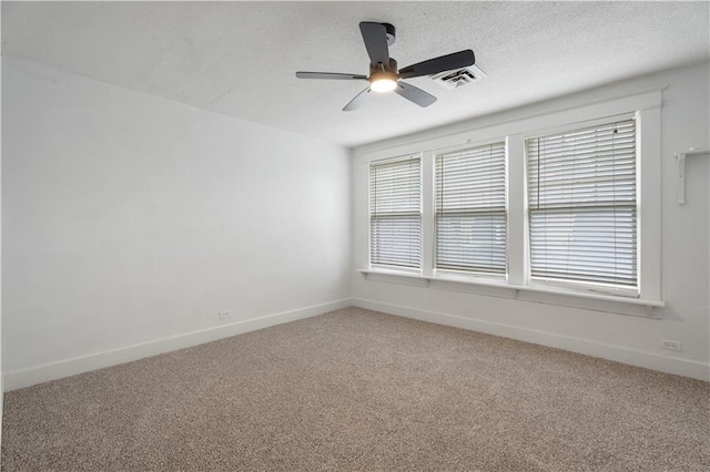 704 Lincoln St, Coffeyville, KS 67337 - unfurnished room featuring light carpet, a ceiling fan, and a textured ceiling