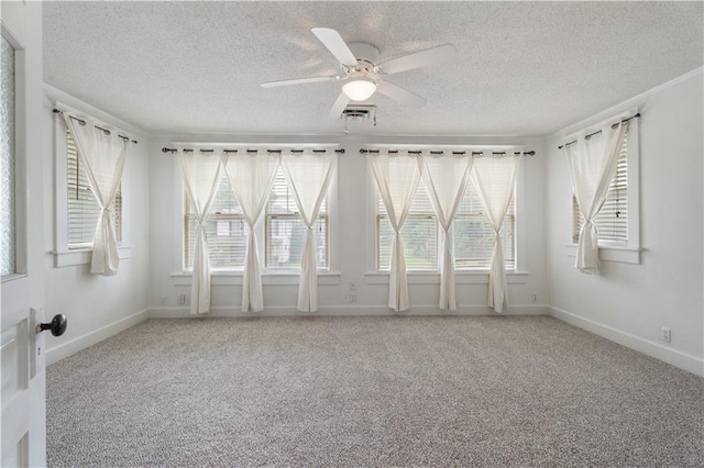 704 Lincoln St, Coffeyville, KS 67337 - unfurnished room with a textured ceiling, carpet floors, and ceiling fan