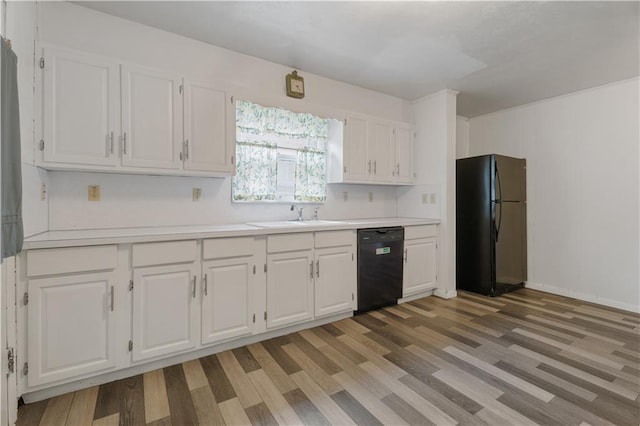 704 Lincoln St, Coffeyville, KS 67337 - kitchen with black appliances, white cabinetry, and light countertops