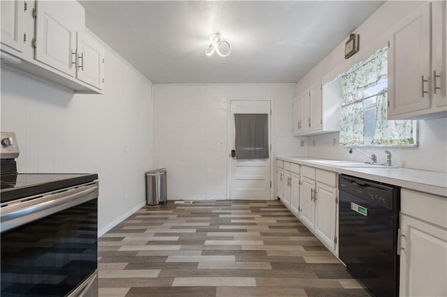 704 Lincoln St, Coffeyville, KS 67337 - kitchen featuring stainless steel range with electric stovetop, dishwasher, light countertops, light wood-type flooring, and white cabinetry