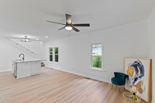 1233 S Pleasant St, Independence, MO 64055 - unfurnished living room with light wood-type flooring, ceiling fan, and recessed lighting