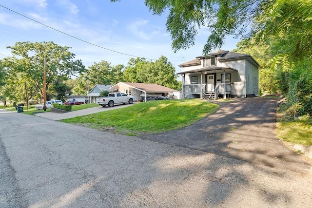 1233 S Pleasant St, Independence, MO 64055 - view of front of property with driveway, covered porch, and a front lawn