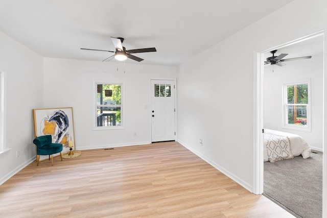 1233 S Pleasant St, Independence, MO 64055 - foyer featuring a ceiling fan, plenty of natural light, and light wood-style flooring