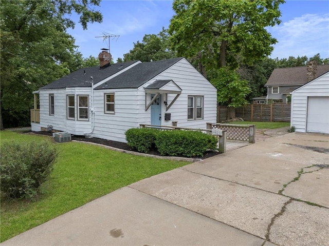 9521 W 60th St, Merriam, KS 66203 - bungalow-style house featuring a chimney, a shingled roof, a garage, concrete driveway, and an outbuilding