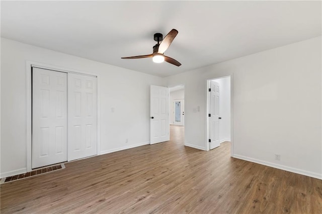 9521 W 60th St, Merriam, KS 66203 - unfurnished bedroom featuring wood finished floors, a closet, and ceiling fan