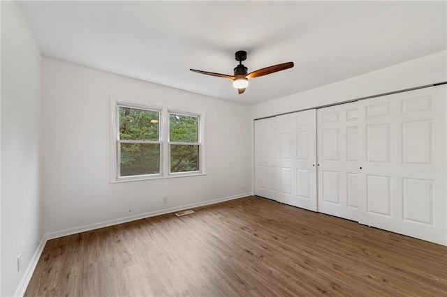 9521 W 60th St, Merriam, KS 66203 - unfurnished bedroom featuring wood finished floors, a closet, and a ceiling fan