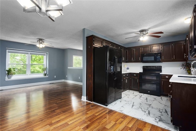 33145 W 88th Ter, De Soto, KS 66018 - kitchen with black appliances, ceiling fan, light countertops, dark brown cabinets, and a textured ceiling