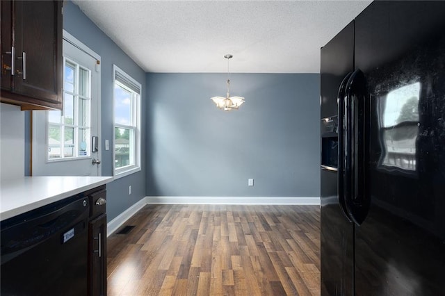 33145 W 88th Ter, De Soto, KS 66018 - kitchen with black appliances, wood finished floors, a chandelier, light countertops, and pendant lighting