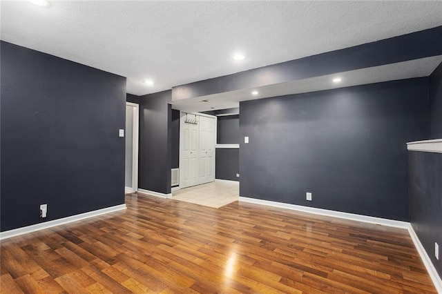 33145 W 88th Ter, De Soto, KS 66018 - spare room featuring wood finished floors, recessed lighting, and a textured ceiling