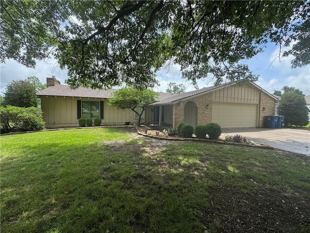 906 S Denman, Chanute, KS 66720 - single story home featuring board and batten siding, an attached garage, a front yard, a chimney, and driveway