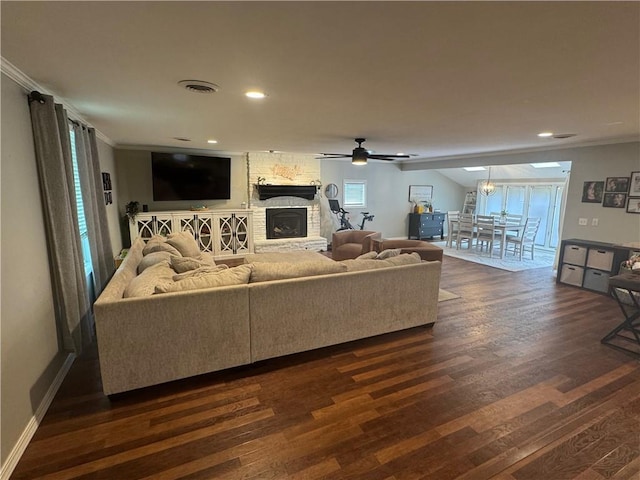 906 S Denman, Chanute, KS 66720 - living room featuring dark wood-style flooring, ornamental molding, a stone fireplace, recessed lighting, and ceiling fan