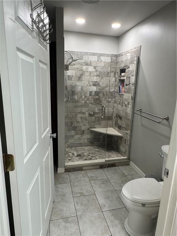 906 S Denman, Chanute, KS 66720 - bathroom with a stall shower and tile patterned flooring