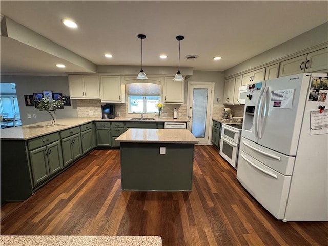 906 S Denman, Chanute, KS 66720 - kitchen featuring white appliances, green cabinetry, recessed lighting, tasteful backsplash, and a kitchen island