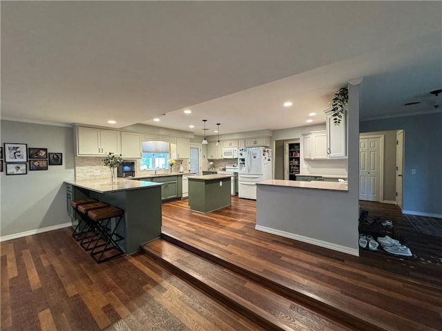 906 S Denman, Chanute, KS 66720 - kitchen featuring white appliances, a peninsula, recessed lighting, dark wood-style flooring, and tasteful backsplash