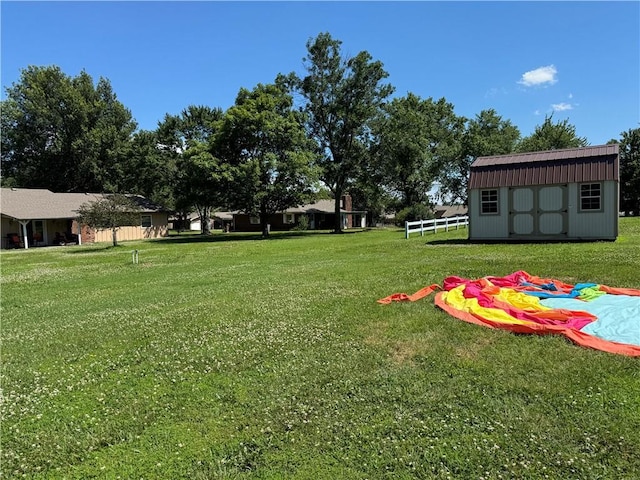 906 S Denman, Chanute, KS 66720 - view of grassy yard featuring a storage unit