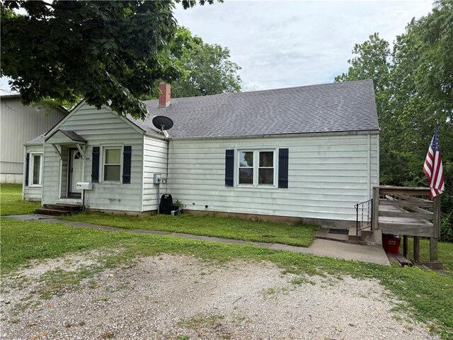 529 S Business Highway 13, Lexington, MO 64067 - view of front facade with roof with shingles, a front lawn, and a chimney