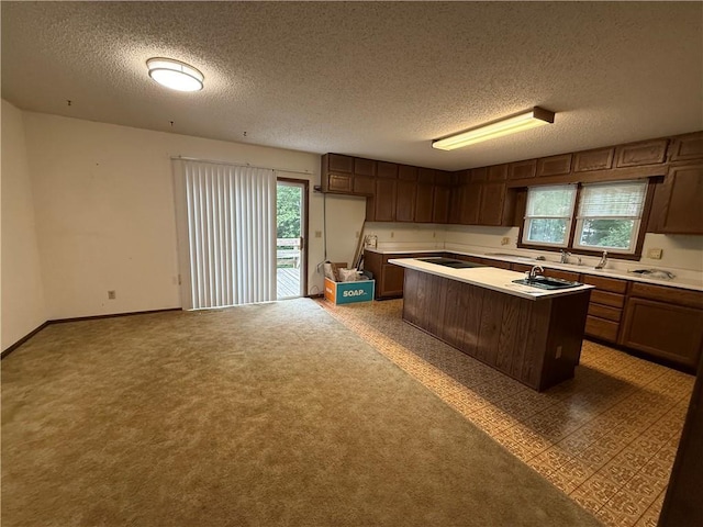 529 S Business Highway 13, Lexington, MO 64067 - kitchen featuring light countertops, a textured ceiling, a kitchen island, and open floor plan
