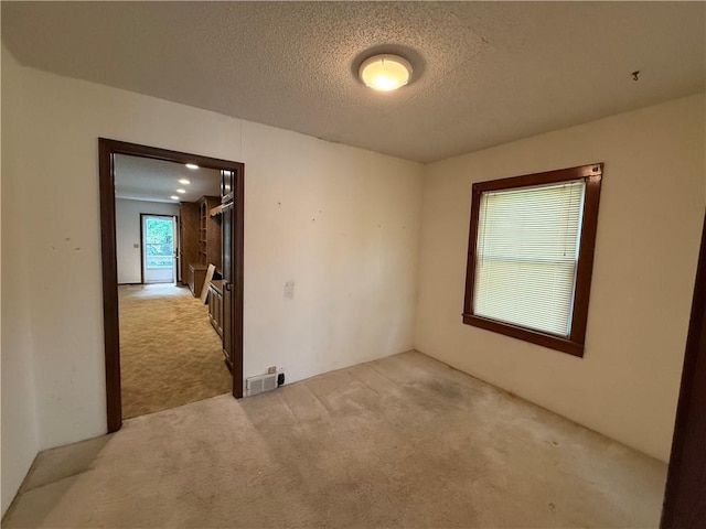 529 S Business Highway 13, Lexington, MO 64067 - carpeted empty room with a textured ceiling