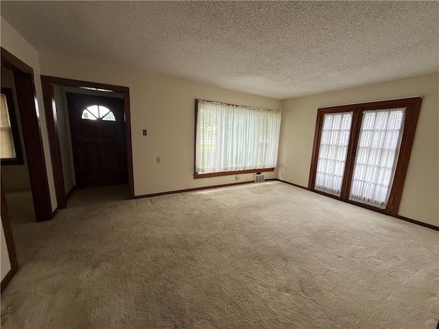 529 S Business Highway 13, Lexington, MO 64067 - carpeted entryway featuring baseboards and a textured ceiling