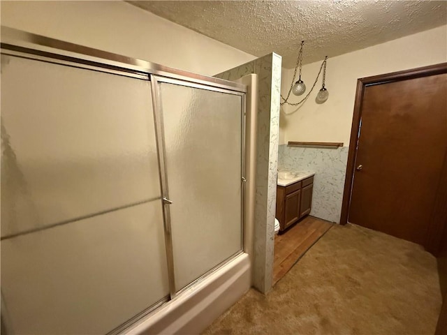 529 S Business Highway 13, Lexington, MO 64067 - full bathroom with a shower with door, vanity, and a textured ceiling
