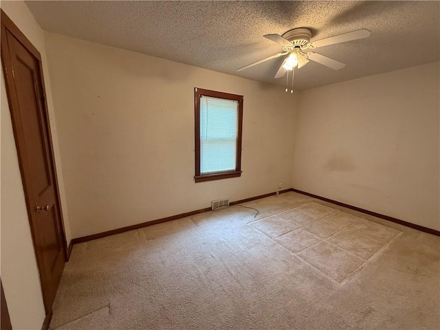 529 S Business Highway 13, Lexington, MO 64067 - spare room featuring a textured ceiling, light carpet, and ceiling fan