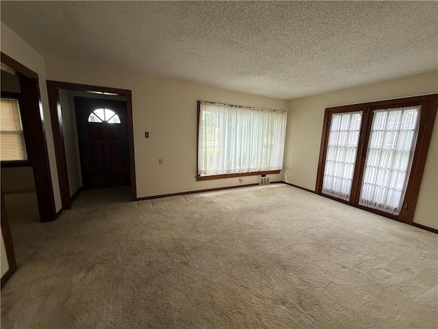 529 S Business Highway 13, Lexington, MO 64067 - unfurnished living room with healthy amount of natural light, carpet, and a textured ceiling