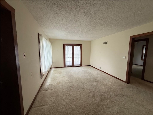529 S Business Highway 13, Lexington, MO 64067 - carpeted spare room featuring a textured ceiling and baseboards