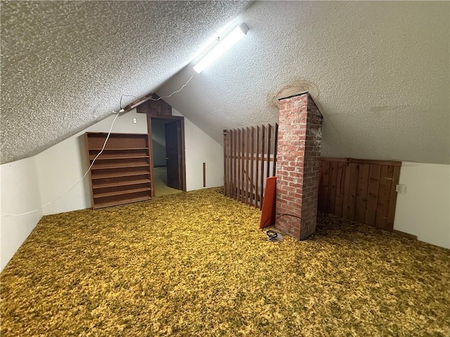 529 S Business Highway 13, Lexington, MO 64067 - additional living space with a textured ceiling, vaulted ceiling, and carpet flooring