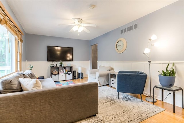 702 Green St, Lees Summit, MO 64063 - living room with a ceiling fan, a wainscoted wall, and wood finished floors