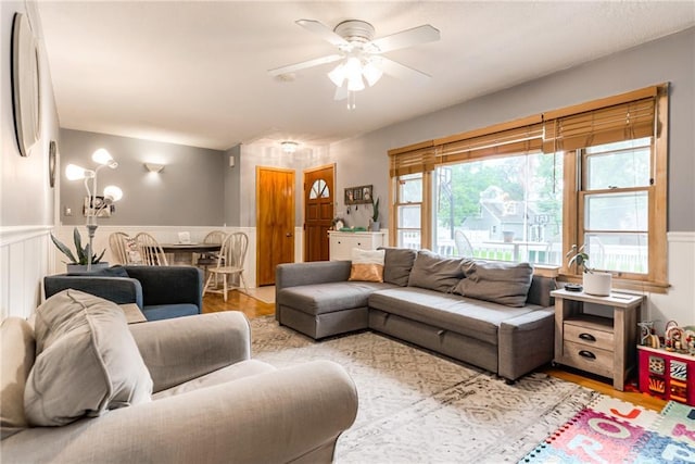 702 Green St, Lees Summit, MO 64063 - living room with a ceiling fan, wainscoting, and wood finished floors