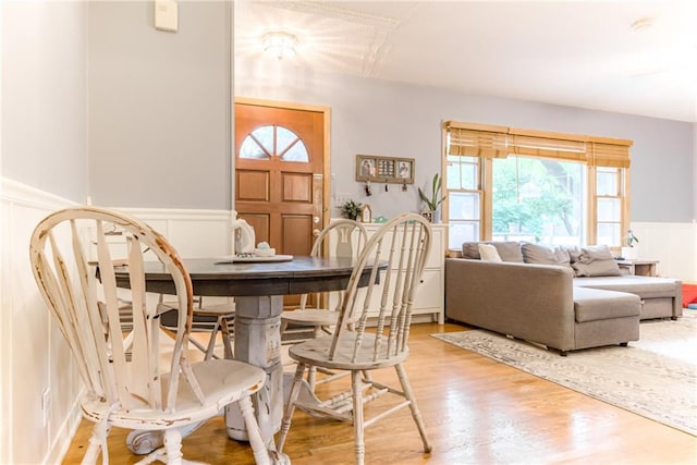 702 Green St, Lees Summit, MO 64063 - dining area with a decorative wall, wainscoting, and light wood-style floors