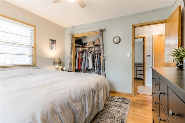 702 Green St, Lees Summit, MO 64063 - bedroom featuring light wood finished floors, crown molding, a closet, and a ceiling fan