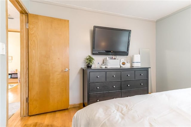 702 Green St, Lees Summit, MO 64063 - bedroom with light wood-type flooring and ornamental molding