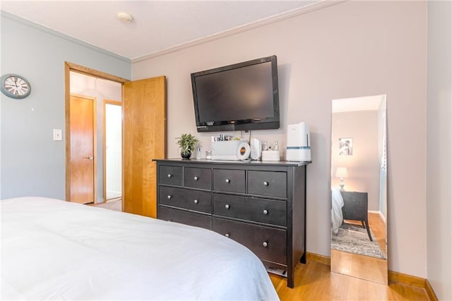 702 Green St, Lees Summit, MO 64063 - bedroom with light wood-style flooring and crown molding